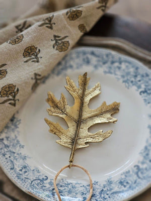 Add a magical touch this season with the Golden Leaves Ornament Set. The set of four exquisitely crafted leaves have a gold distressed finish that evokes timeless charm. Made from resin, each piece showcases delicate embossed details, adding rich texture and an elegant vintage allure. This set of four brings a refined touch to your seasonal celebrations. 