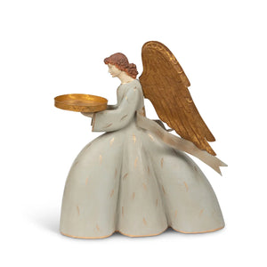 Introduce understated luxury to your decor with this Gold Wing Angel Candle Holder. Standing as a refined focal point, this sculptural piece marries functional candlelight with decorative sophistication. The aged gold winged design and chateau-gray dress offer French country charm. The golden tray holds a pillar candle up to 3" diameter. This eye-catching piece evokes the timeless elegance of heirloom treasures, making it a distinguished choice for discerning collectors.
