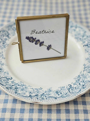Elevate your event with our Gold and Glass Easel Picture Frame Place Card Holder Set. Featuring a refined vintage-inspired design accented in gold, these floating picture frames offer a unique way to create place card settings or table numbers that will delight guests and spark conversation. &nbsp;Perfect for weddings, parties, or any gathering, their elegant gold finish and clear glass let your creativity shine—endless possibilities await to make your event memorable! includes three empty 3 x 3 frames 