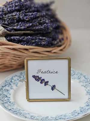 Elevate your event with our Gold and Glass Easel Picture Frame Place Card Holder Set. Featuring a refined vintage-inspired design accented in gold, these floating picture frames offer a unique way to create place card settings or table numbers that will delight guests and spark conversation. &nbsp;Perfect for weddings, parties, or any gathering, their elegant gold finish and clear glass let your creativity shine—endless possibilities await to make your event memorable! includes three empty 3 x 3 frames 