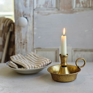 This Golden Aged Golden Aged Chamberstick Candle Holder features a distressed gold patina that makes it feel like an old-world heirloom. Holds a reuglar size taper candle. Add candle rings, ornaments or potpourri for an elegant bookshelf or tabletop accent. It is made of metal with a highly distressed finish. Candle not included.  L: 6.50" W: 5.25" H: 3.75" 