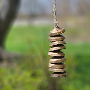 Add visual interest and a subtle echoing melody with our temple-style chimes. The quiet chiming is created by the multiple layers of distressed brass bells. The calming tune adds a zen-like feel to the home or garden. The metal will develop a rusted patina if left outdoors. (Shepherd's Hook not included) Each moon chime is 3" diam. 10"H