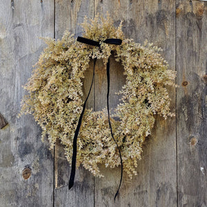Enhance your seasonal decor with the sophisticated charm of our Golden Cypress Wreath adorned with a Black Velvet Ribbon. Crafted from faux cypress, this wreath offers a distinctive and refined look that brings a subtle, moody elegance to any doorway or interior space.19" Diam