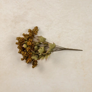 Let fall's warm vibrancy fill your farmhouse with this Golden Green Hops Bush. This faux floral pick is lush and packed with aged hops blossoms, making it an easy choice to fill any basket or vase. It features golden, green and brownish hues for an authentic faded appearance. The wire stems make it easy to shape to fit any vase or basket. Each pick is approximately 14”H.