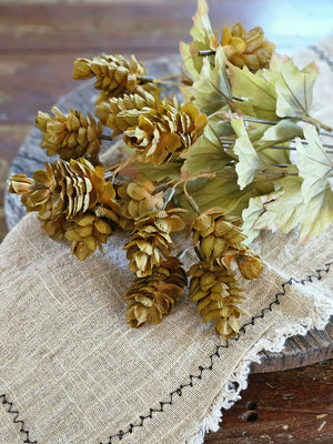 Let fall's warm vibrancy fill your farmhouse with this Golden Green Hops Bush. This faux floral pick is lush and packed with aged hops blossoms, making it an easy choice to fill any basket or vase. It features golden, green and brownish hues for an authentic faded appearance. The wire stems make it easy to shape to fit any vase or basket. Each pick is approximately 14”H.