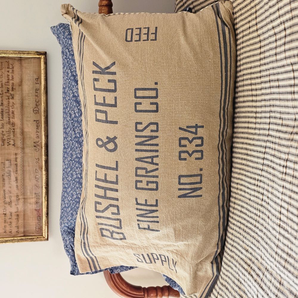 Add rustic and vintage farmhouse style to your bedroom with the Grain Sack Pillowcase, Set of Two. Features a dual-sided look for flexible styling. The front features stenciled, BUSHEL PECK FINE GRAINS CO. in grey on natural tan base. Each pillowcase reverses to a vintage ticking stripe in nickel grey and soft creme. 