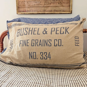 Add rustic and vintage farmhouse style to your bedroom with the Grain Sack Pillowcase, Set of Two. Features a dual-sided look for flexible styling. The front features stenciled, BUSHEL PECK FINE GRAINS CO. in grey on natural tan base. Each pillowcase reverses to a vintage ticking stripe in nickel grey and soft creme. 