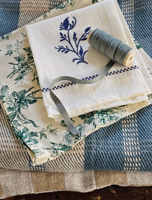 Add vintage cottage charm to your table with our Green Floral Toile Napkin Set. The set of four dinner napkins features a detailed green floral design against a vintage ivory background and elegant hemstitched edges. Set of four. 100% cotton. 20" x 20"  Machine wash separately cold water tumble dry low warm iron