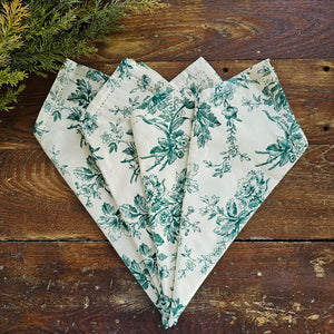Add vintage cottage charm to your table with our Green Floral Toile Napkin Set. The set of four dinner napkins features a detailed green floral design against a vintage ivory background and elegant hemstitched edges. Set of four. 100% cotton. 20" x 20"  Machine wash separately cold water tumble dry low warm iron
