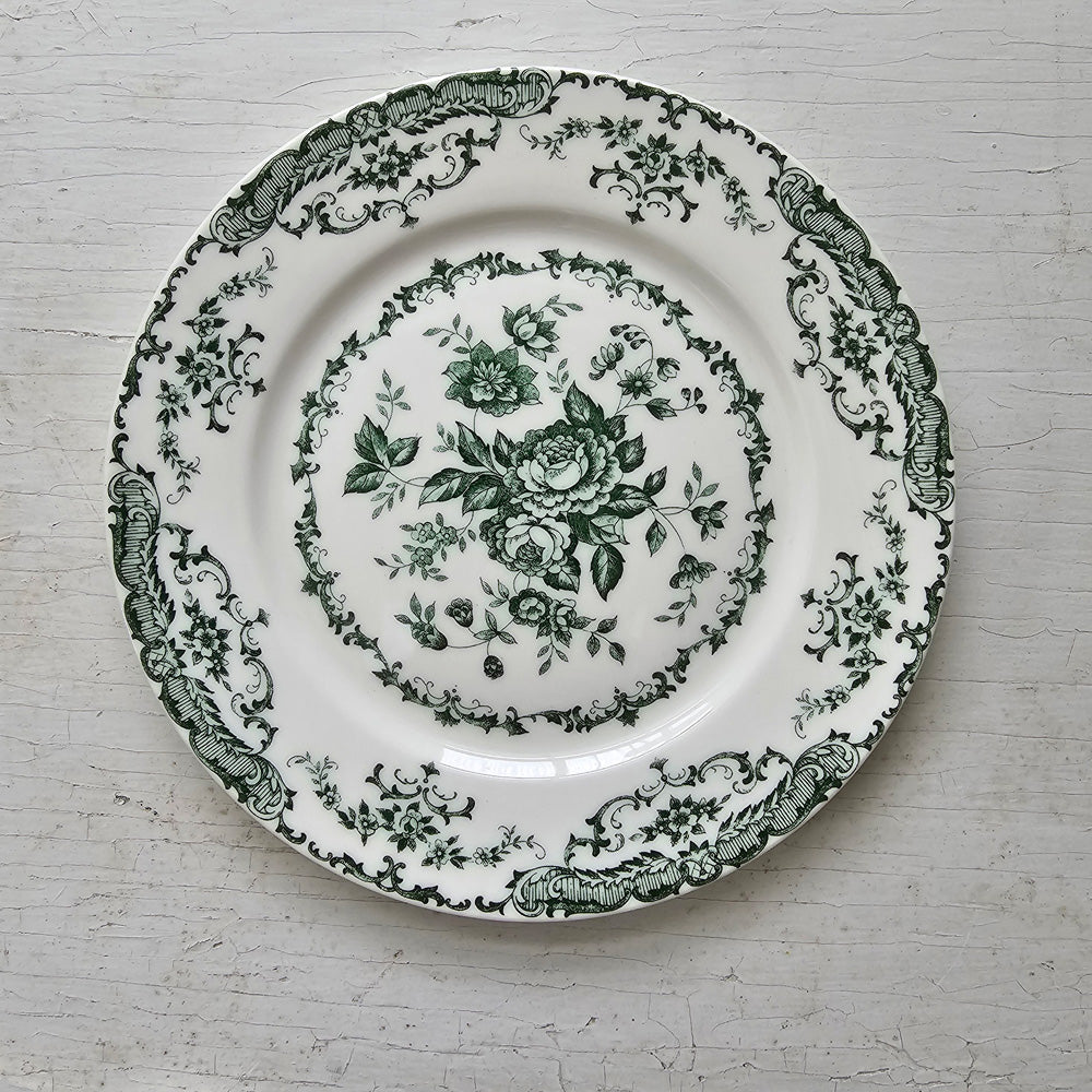 Inspired by antique transferware, our Green Floral Transferware Plate lends French country cottage style to any shelf, tabletop or dinnerware collection. A vintage classic, transferware has adorned the shelves of American farmhouses for centuries. The delicate floral pattern in green on an antique white background. Perfect for desserts and salads. Includes one plate. 8" Diam