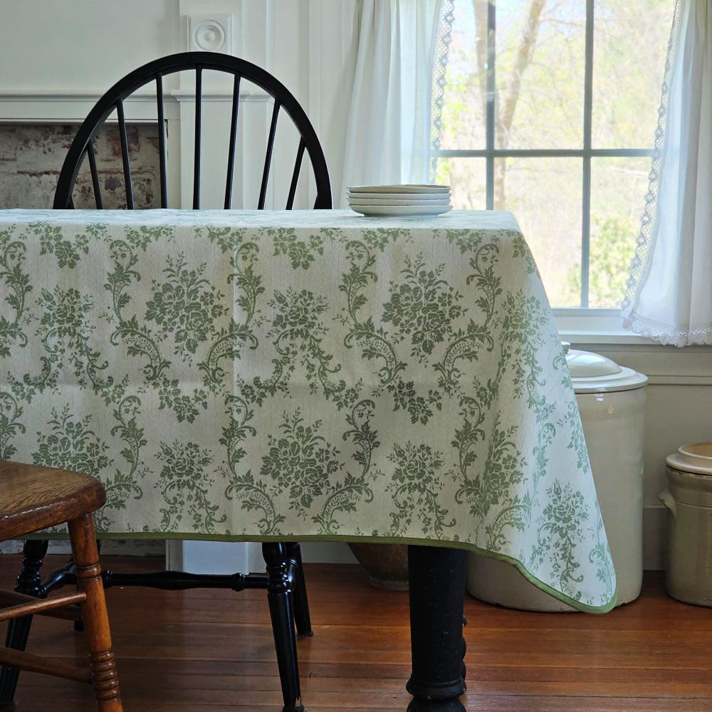 Our Green French Floral Tablecloth lends an easy elegance to any occasion. Features a pale green background with raised, darker green floral design and green trim. It creates an instant vintage feel inspired by old European farmhouse style. This is a durable, easy-care tablecloth, perfect for everyday use. Machine wash. Polyester.