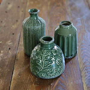 The Forest Green Vase Set brings a refined touch of nature into your living space, combining texture and elegance effortlessly. This curated trio features three distinct ceramic vases, each showcasing unique shapes and intricate textured patterns that create visual interest and depth. 