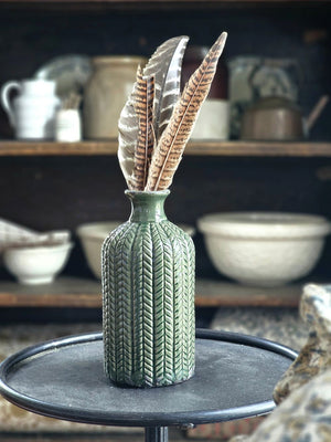 The Forest Green Vase Set brings a refined touch of nature into your living space, combining texture and elegance effortlessly. This curated trio features three distinct ceramic vases, each showcasing unique shapes and intricate textured patterns that create visual interest and depth. Perfect for adding sophistication to any room, these vases complement both fresh blooms and dried arrangements. 