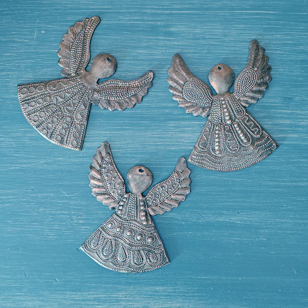 Each of these handmade Hammered Tin Angel Ornaments is a tiny work of art.
Sold as a set of three, each angel is hand-cut, and embossed with care. No two are alike — every set is a vibrant mix of designs, perfect for spreading joy and inspiration. They make wonderful gift-toppers, ornaments, wall decor accents, or thoughtful tokens tucked into greeting cards or gift bags. 