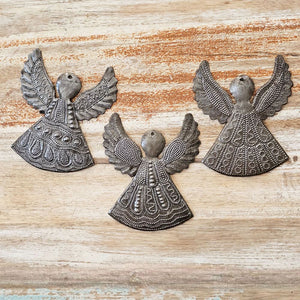 Each of these handmade Hammered Tin Angel Ornaments is a tiny work of art.
Sold as a set of three, each angel is hand-cut, and embossed with care. No two are alike — every set is a vibrant mix of designs, perfect for spreading joy and inspiration. They make wonderful gift-toppers, ornaments, wall decor accents, or thoughtful tokens tucked into greeting cards or gift bags. 