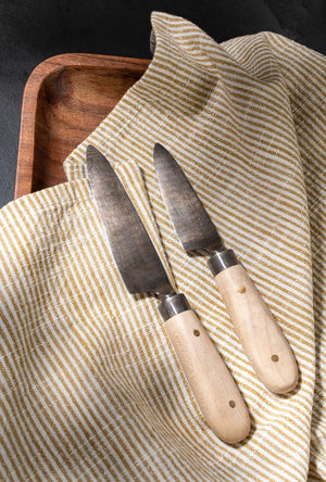 Upgrade your culinary tools with these Hand-Forged Cheese Knives. Featuring a combination of beechwood handles and stainless steel blades, these hand-forged knives offer precision and durability for everyday use. Beautifully packaged, they make a thoughtful hostess gift or a stylish addition to your flatware collection. Designed with sustainable materials and traditional crafting methods, these knives blend practicality with artisanal charm.