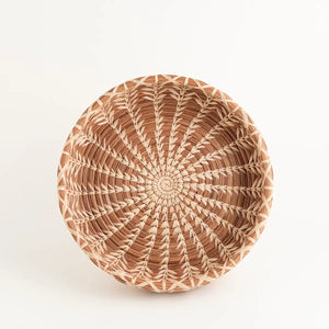 The Handwoven Cloud Forest Basket Bowl adds genuine elegance and warmth to any setting. Perfect for holding pastries at breakfast or organizing keys and essentials near your door, each basket is a testament to craftsmanship. Created of sustainable pine needles by women using time-honored techniques, these fair trade pieces support economic development and education for the women in La Fe through a dedicated nonprofit partnership.