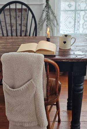 Every sip from our Rustic Heart Mug is a reminder to slow down and appreciate the simple things in life. This stoneware mug is the perfect shape to hold, and the hand-painted hearts spread a little love. Features a rustic light beige glaze with a raised black heart on the outer portion of the mug and a painted black heart on the inside as well.