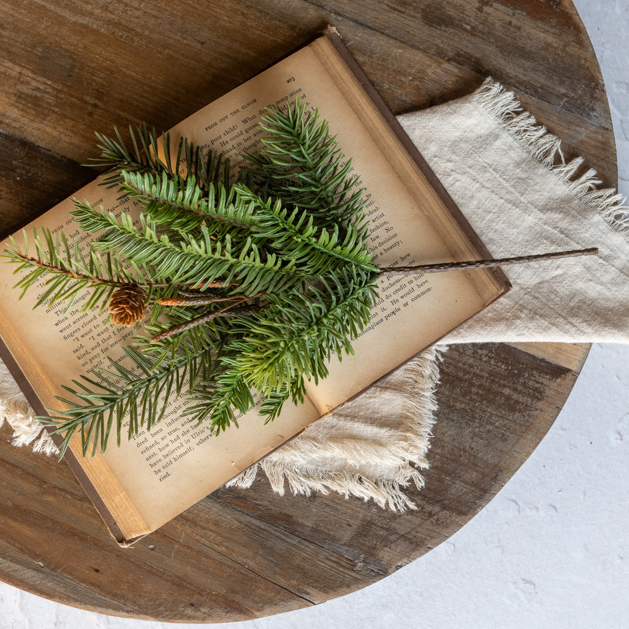 Our Douglas Fir Greens with Pine Cone Pick makes a great filler for baskets and holiday arrangements. The faux Douglas Fir Greens with Pine Cone Pick brings fresh, earthy greenery to your farmhouse decor. Perfect for adding cabin style or a rustic twist, this realistic greenery with pine cone accents provides a charming decorative accent all year long. Includes one pick. Vases not included. 13.5"H