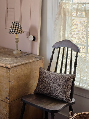 Our Nutmeg Metal Spindle Lamp with Buffalo Check Lampshade creates a cozy old cottage feel. Perfect for bedside tables and desktops, this lamp features a metal base with a warm colonial tan finish. It is topped off with a clip on black and tan buffalo check lampshade. This lamp plugs in and has an on/off switch built into the cord. 