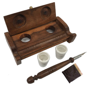 The Inkwell Stand with Porcelain Inkwells and Wood Nib Pen Set makes a perfect desk accessory reminiscent of early Colonial days. The set features a wood inkwell stand that opens and closes, two white porcelain inkwells, a wood nib writing pen, and a bag black ink powder so you can easily get started.