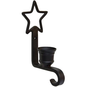 The Primitive Star Taper Candle Sconce with Hook adds a sweet touch to any room. The relaxed design features a metal taper holder with black finish. The top of the holder features a star shape and a pre-drilled hole for hanging. The holder curves up at the base, featuring a small hook for hanging ornaments, candles and more.