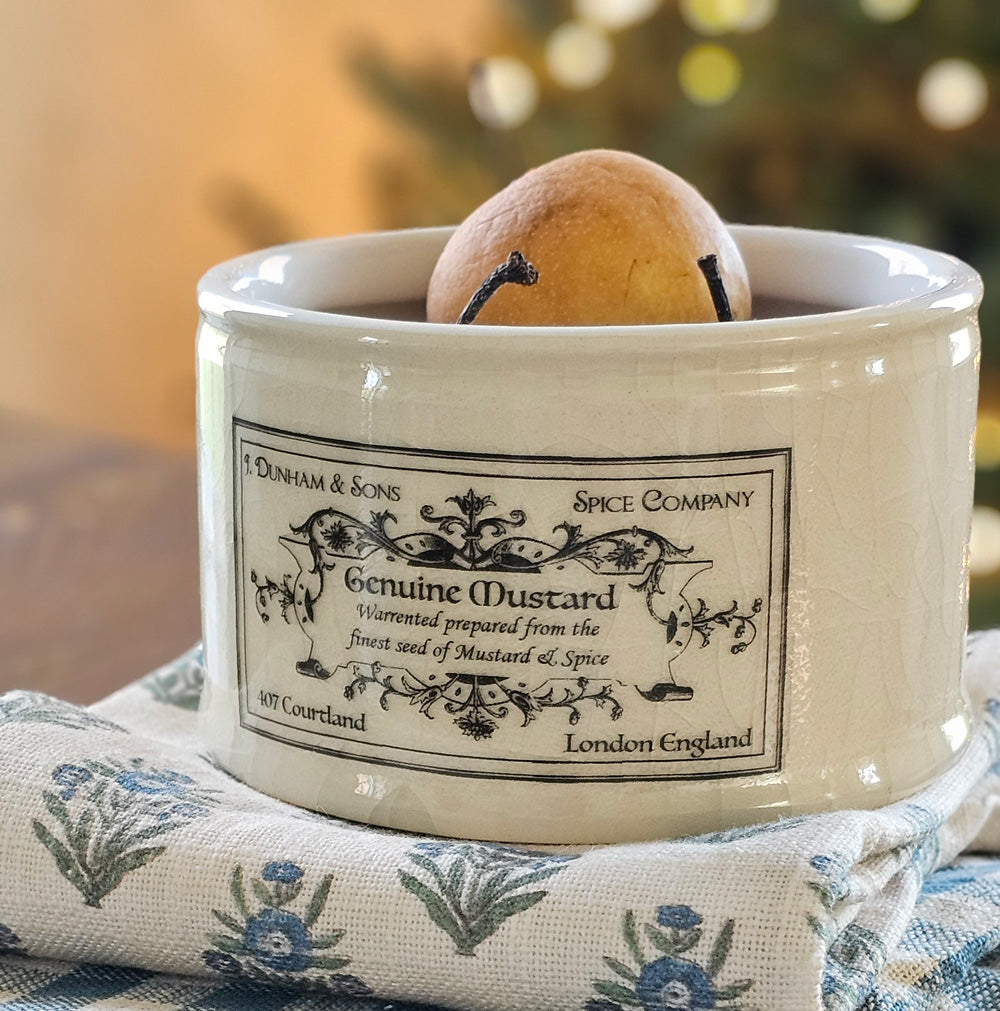 This handsome Ironstone Style Mustard Crock is inspired by 19th century ironstone from potteries throughout England. These reproduction crocks have an oatmeal color with a decorative black logo. This mustard crock features an old-timey logo. This beautiful accent crock adds old-world charm to any room. Use to store cooking utensils or display your favorite flowers. (utensils and flowers not included) 
