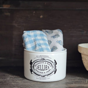 This handsome Jelly and Jam Crock is inspired by 19th century ironstone from potteries throughout England. This reproduction crock has a creamy white color with a decorative black old-timey logo. This beautiful accent crock adds old-world charm to any room. Use to store cooking utensils or display your favorite flowers.