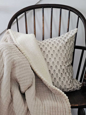 The Kantha Quilted Stitch Sherpa Throw is a true testament to the beauty of hand work and traditional craft. Layers of stone-washed 100% cotton voile, in a natural linen hue, are sewn together with lines of hand kantha stitching to create an extremely textured look that’s rich in culture. For even more texture and warmth, the throw features a cozy thick sherpa backing for snuggling up. Machine wash - gentle cycle, do not tumble dry, iron on low, do not dry clean. 50" x 60"