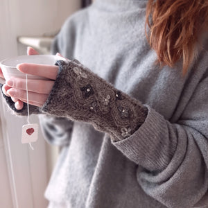 Our Knit and Fleece Handwarmers allow you to keep your fingers free while keeping your hands snug and warm. These are perfect for worker-bees that still enjoy the cozy warmth of a glove. The  super soft fleece lining hugs your hands while the 100% New Zealand wool exterior offers pretty flower details with faux diamonds to add a bit of sparkle. One size fits most. 100% wool exterior, 100% polyester lining.