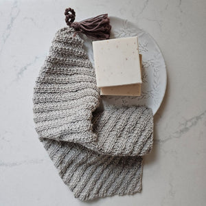 This super soft vintage style Knit Washcloth with Tassel adds a bit luxury to your bathing experience. Handmade of 100% Certified Organic Cotton, this knit washcloth, with its diagonal weave pattern, is designed for scrubbing without damaging the skin. Featuring a braided tassel that serves as a hook for drying while adding a decorative touch. The neutral, warm gray color complements any color scheme. 
