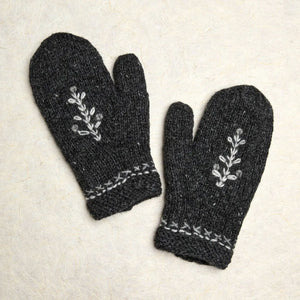 Crafted with intention, these hand-knit mittens marry understated Nordic style with everyday warmth. The charcoal foundation provides a versatile canvas for delicate white tree embroidery and cuff detailing that whispers rather than shouts. Lined with plush fleece, they transform ordinary moments—a morning stroll, a quick errand, or cradling your favorite beverage—into small rituals of comfort.