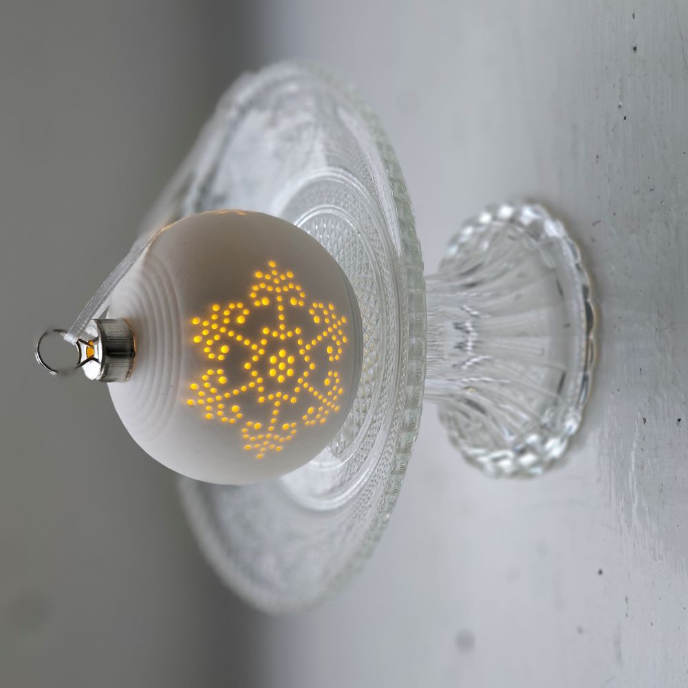 The Lighted Snowflake Ornament Set brings an enchanted winter touch to your home. Features a crisp, white un-glazed ceramic, lending a quiet elegance with an organic, minimalist feel. The snowflake design has a lace-like quality. Each has a flat bottom, so it can easily sit on a shelf or hang from a tree. 