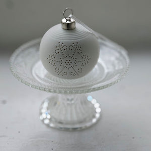 The Lighted Snowflake Ornament Set brings an enchanted winter touch to your home. Features a crisp, white un-glazed ceramic, lending a quiet elegance with an organic, minimalist feel. The snowflake design has a lace-like quality. Each has a flat bottom, so it can easily sit on a shelf or hang from a tree. 