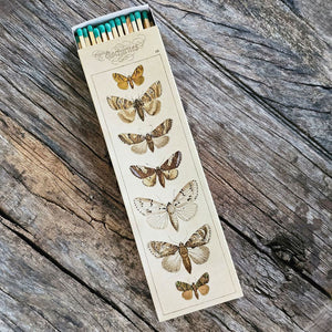 These stylish long wood matches, with a moth design inspired by old illustrations, are the perfect complement to any space. Modern, chic, with a vintage graphic design, they are perfect for any room. The match striker is side of the box for easy lighting. Safety matches, 50 sticks per cardboard box. 