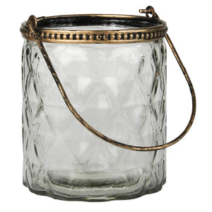 Add a bit of magical ambiance with our Lucia Glass and Gold Votive Holder with handle. Suspended candlelight is a centuries old way to add ambiance and this holder with handle serves just the purpose. Pressed glass and antique brass create a global-chic luminary. Enchanting when hung alone and exponentially dramatic when amassed. 3.5" diam x 4"H