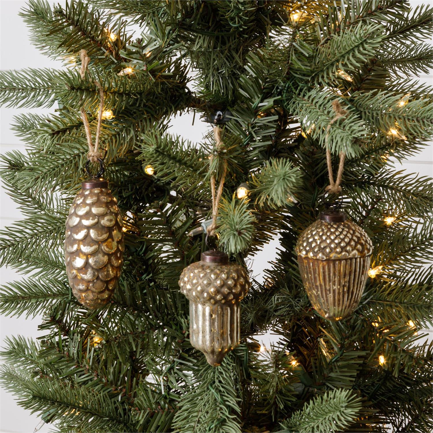 Add a magical vintage touch this season with our Mercury Glass Nuts and Pine Cone Ornament Set.&nbsp; The mirrored glass of each ornament has a distressed finish which captures the time-worn sparkle of vintage mercury glass. The aged, cloudy patina makes each feel just like an antique shop find. Perfect for any season, this Mercury Glass Nuts and Pine Cone Ornament Set will brighten your farmhouse or cottage. Features 3 aged glass ornaments with twine loops for hanging. Approximately 3" Diam x 4"H