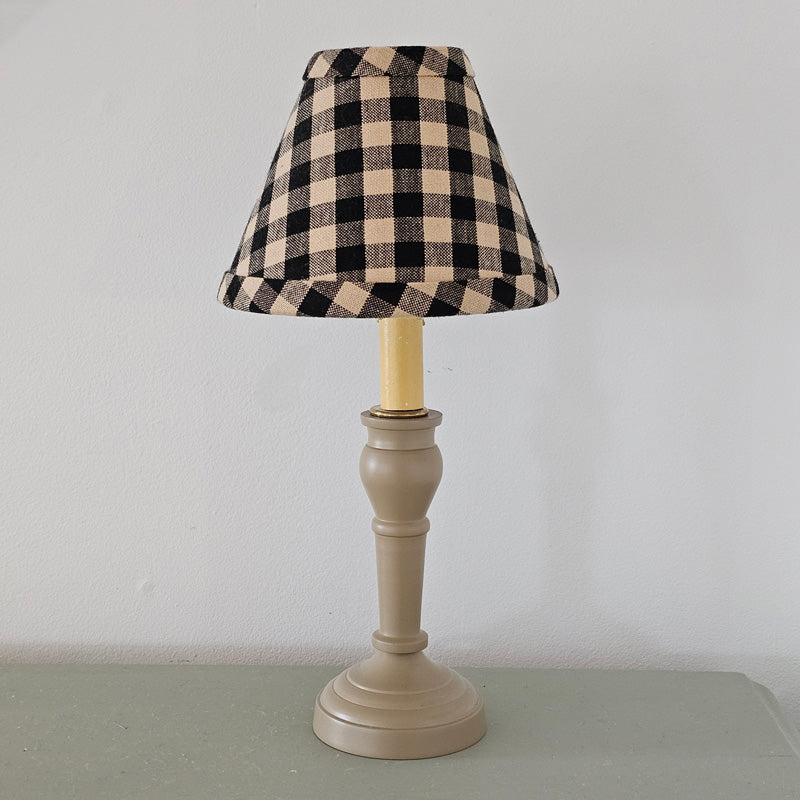 Our Nutmeg Metal Spindle Lamp with Buffalo Check Lampshade creates a cozy old cottage feel. Perfect for bedside tables and desktops, this lamp features a metal base with a warm colonial tan finish. It is topped off with a clip on black and tan buffalo check lampshade. This lamp plugs in and has an on/off switch built into the cord. 