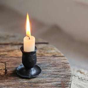 Add rustic ambiance with our Hand-Forged Taper Candle Holder. Featuring a primitive and minimalist design, this black metal holder boasts a hand-forged finish that adds an old-school blacksmith look. Perfect for adding a quiet simplicity to any room. Holds regular size taper candle. Taper candle not included