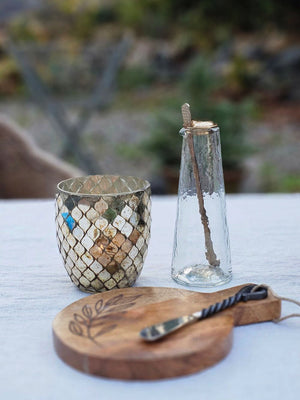 The Mini Glass Carafe with Gold Spoon makes the perfect addition to your kitchen or cocktail bar. With its elegantly tapered body and thoughtfully designed spout, the gently hammered Mini Carafe combines form and function in seamless harmony. Crafted to facilitate effortless drink preparation and serving, it is accompanied by a slender brass spoon that complements the carafe’s refined texture and finish. ideal for serving infused waters, cocktails, or artisanal beverages