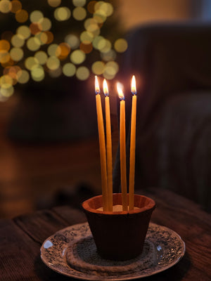 These slim Monastery Beeswax Taper Candles offer a unique touch that will add a sweet charm and the warm scent of honey to any room. These beautiful 1/4" by 8" tapered beeswax candles make a stunning natural element that provide soft bright light as they burn. Come as a set of 10 wrapped in velvet ribbon. Candles burn for 1.5 hours. Perfect to use for meditation or as birthday candles. Set of 10. Ribbon color will vary.