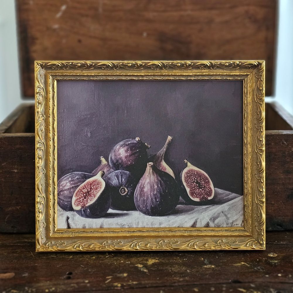 The Moody Fig Still-Life showcases the fruit's natural beauty with its rich, deep purple tones and intricate texture. Each print is designed to replicate French antique artwork. These beautiful antique style prints are featured in an intricately crafted frame and finished with a golden bronzed patina, adding depth and character to your space. These art pieces are printed on a high-quality canvas with a soft velvet backing and a jagged gold hanger.