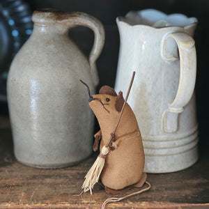 Mouse Cleaner is a charming tea-stained brown fabric mouse clutching a tiny straw broom