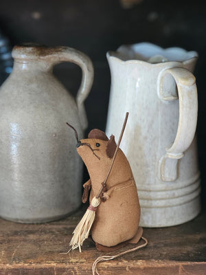 Mouse Cleaner is a charming tea-stained brown fabric mouse clutching a tiny straw broom