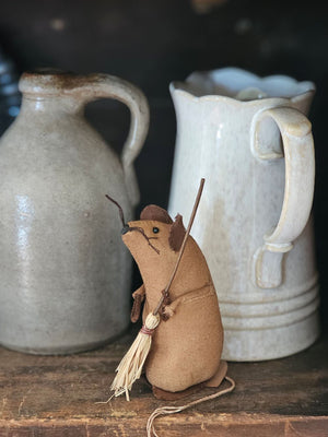 Mouse Cleaner is a charming tea-stained brown fabric mouse clutching a tiny straw broom