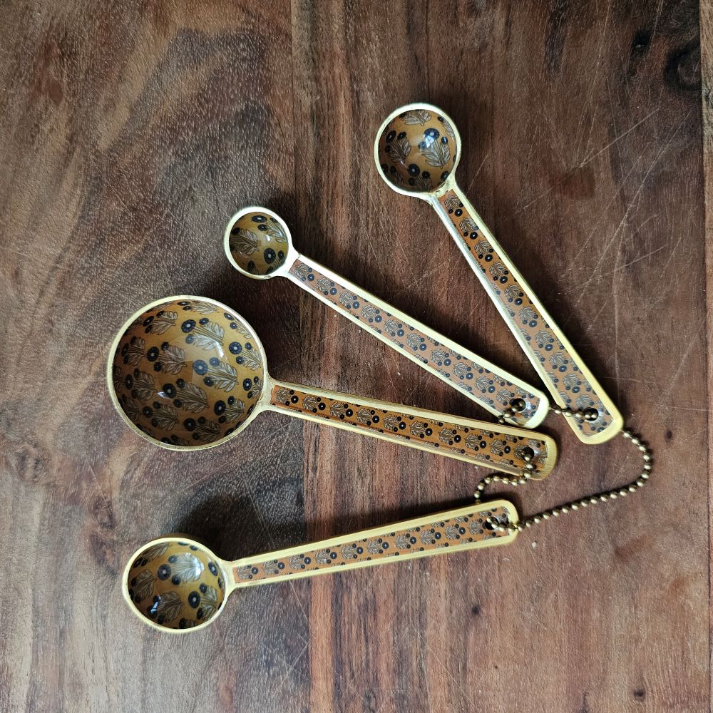 Elevate your culinary rituals with the Mustard Block Print Enameled Measuring Spoon Set, where timeless artisanal design meets everyday functionality. Each spoon features an exquisite block print pattern rendered on a warm mustard tone, complemented by a refined matte gold finish that catches the light with understated elegance.