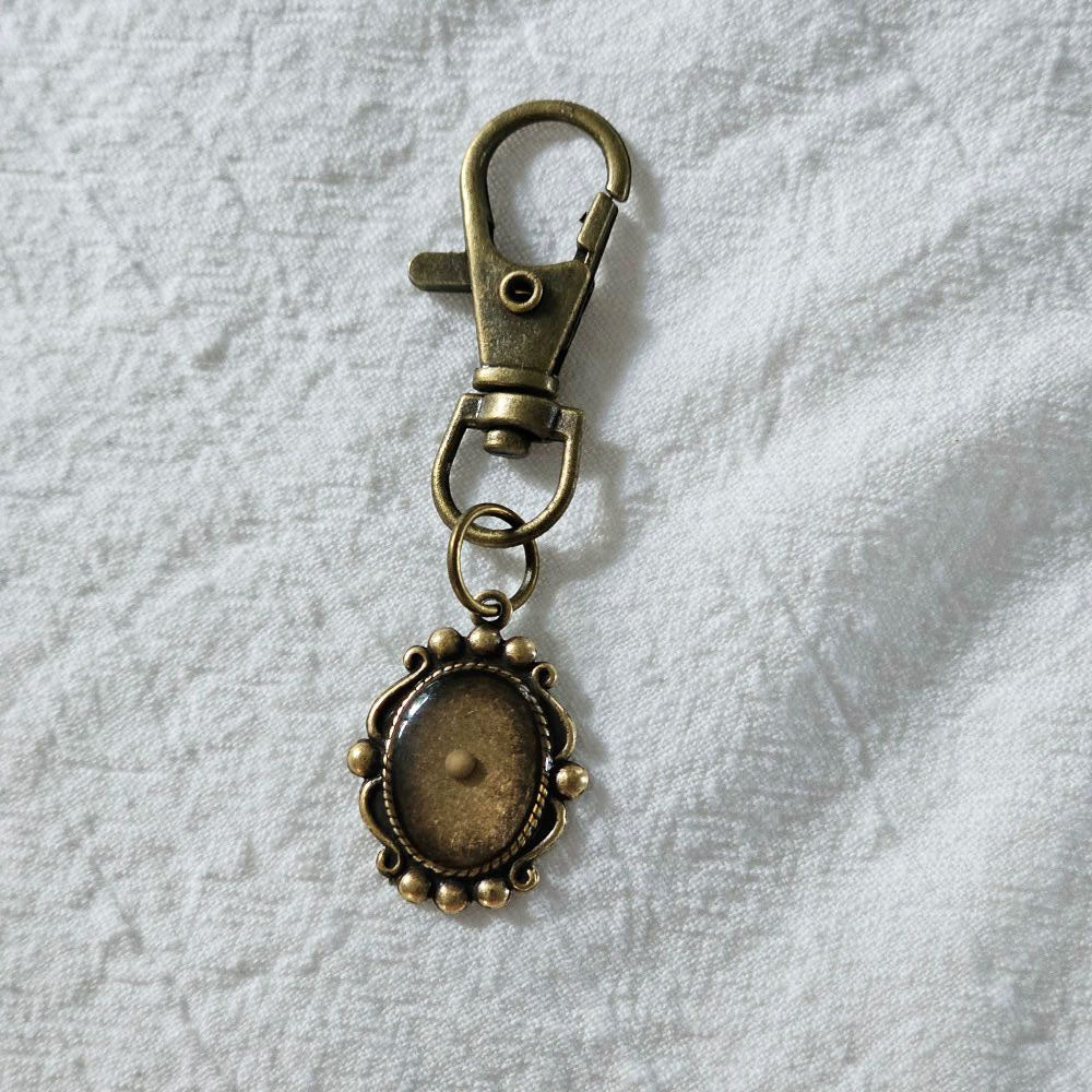 The Mustard Seed Bag Charm features an antique bronze finish with an encased mustard seed. It can be used as a zipper pull, bag charm or keychain clip-on charm. It reminds us of the scripture of Matthew 17:20 that tells us that with just a little faith, we can move mountains. 0.75" x 2.5"
