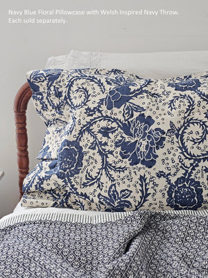 Add beautiful texture and vintage style to your bedroom with the Navy Blue Floral Pillow Case Set. The floral pattern, in navy blue against a natural cream base, lends a country cottage look that coordinates well with other patterns. The set includes two 21x26 pillow covers with additional 4-inch ruffles at the opening. The 100% thick cotton weave features double-sewn seams for extra durability as well as extra length to ensure good coverage of your fill pillow (not included). 