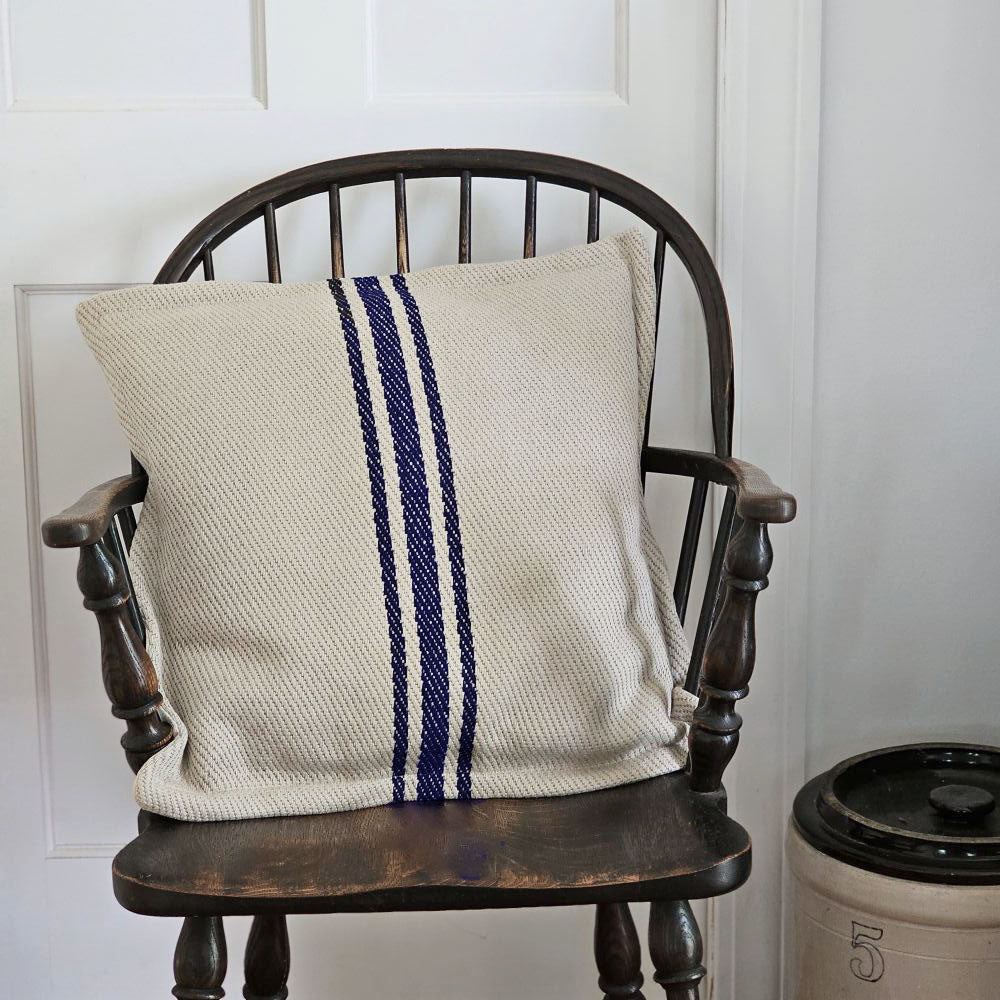 The Grain Sack Style Oatmeal and Navy Stripe Pillow adds texture and vintage charm to any room. Its warm oatmeal color and dark navy stripes give it French Country farmhouse feel. Includes a zipper closure for easy care. Cotton/Linen outer with polyester fiber fill. 20"L x 20"H