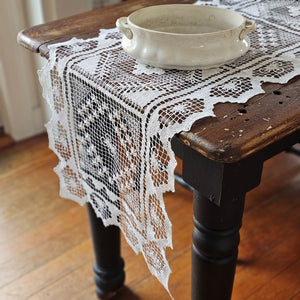 Our Old Tuscany Lace Table Runner adds old-world charm to any room. This sheer lace white runner has a dreamy vintage quality that is perfect for creating an country farmhouse look or for those who love cottage style. Features translucent white lace embroidered with a floral design and scalloped edging. 100% mercerized Cotton thread. 16”W x 45”L

Create easy no-sew cafe lace curtains with our curtain ring clips. Simply add two runners with one set of clips to create an old-world look.